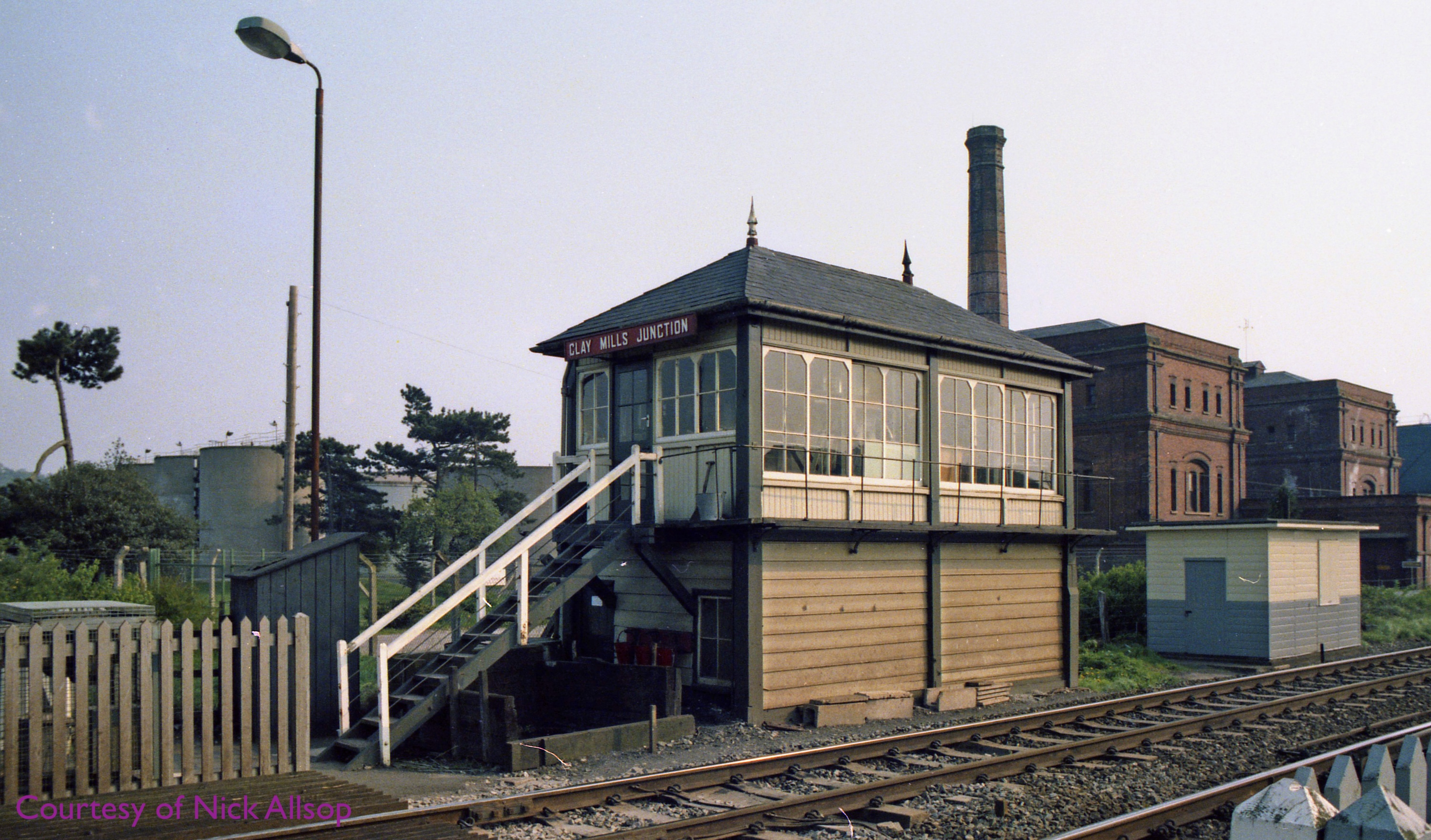 A photograph looking at the CLay Mills Junction Shinting Frame (gate box) in 1984. The CLay Mills Pumong Station is behind the box.